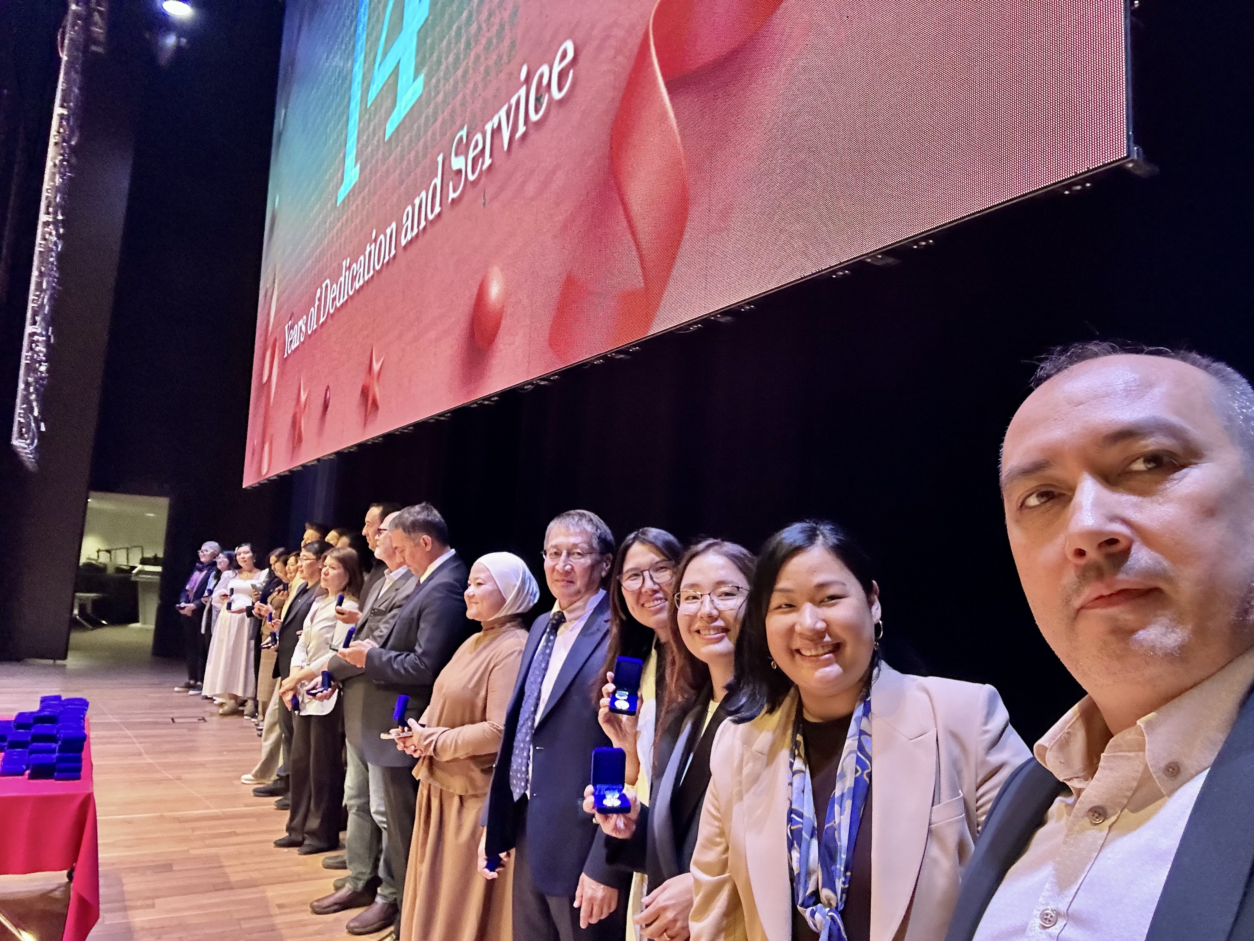 Receiving the 14 years of service recognition at Nazarbayev University